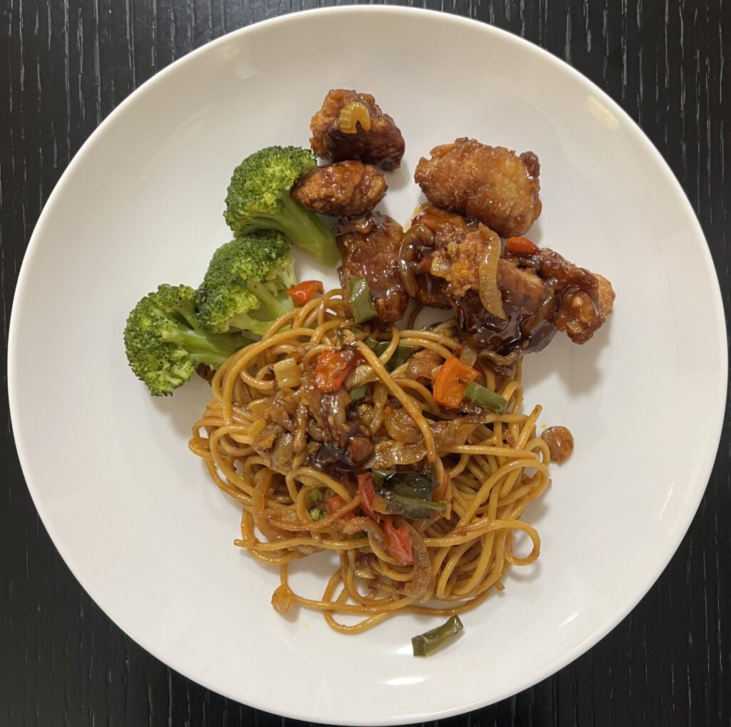 Prato sino-americano com orange chicken, macarrão ao estilo chow mein e brócolis